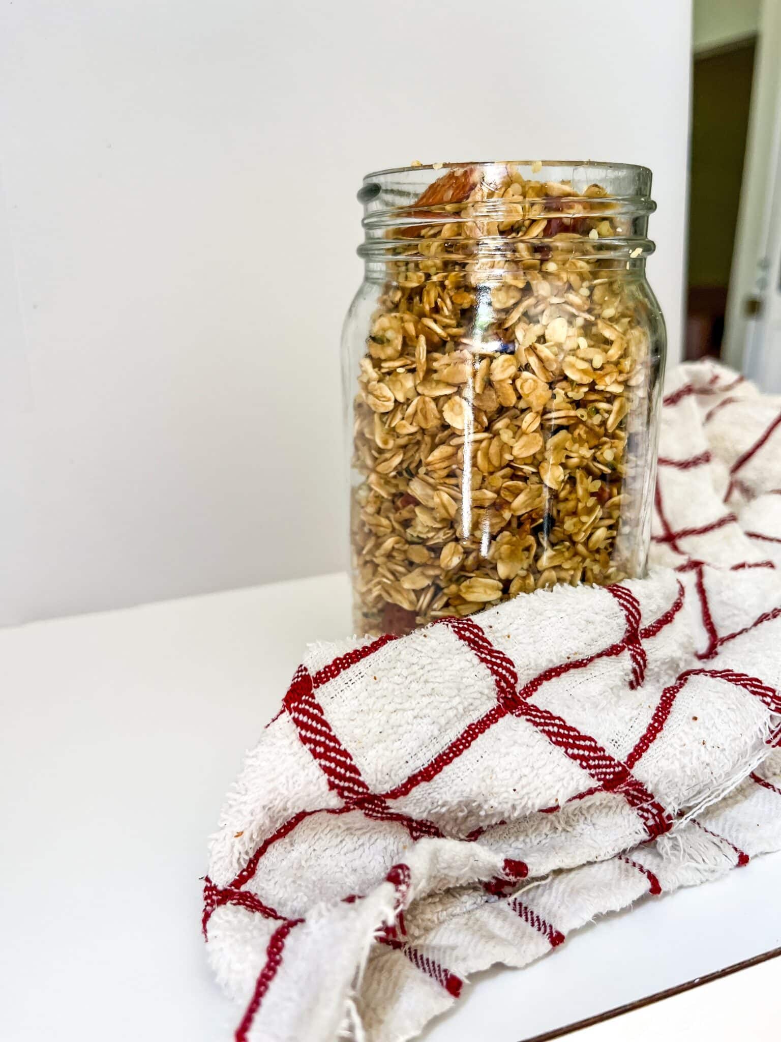 Almond Vanilla Granola in mason jar with tea towel in front