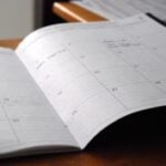 Monthly schedule and planning notebook on a desk