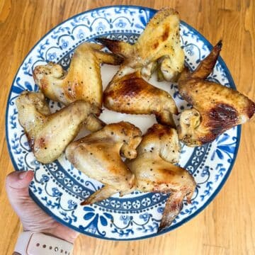 Seven Chicken wings on a blue plate