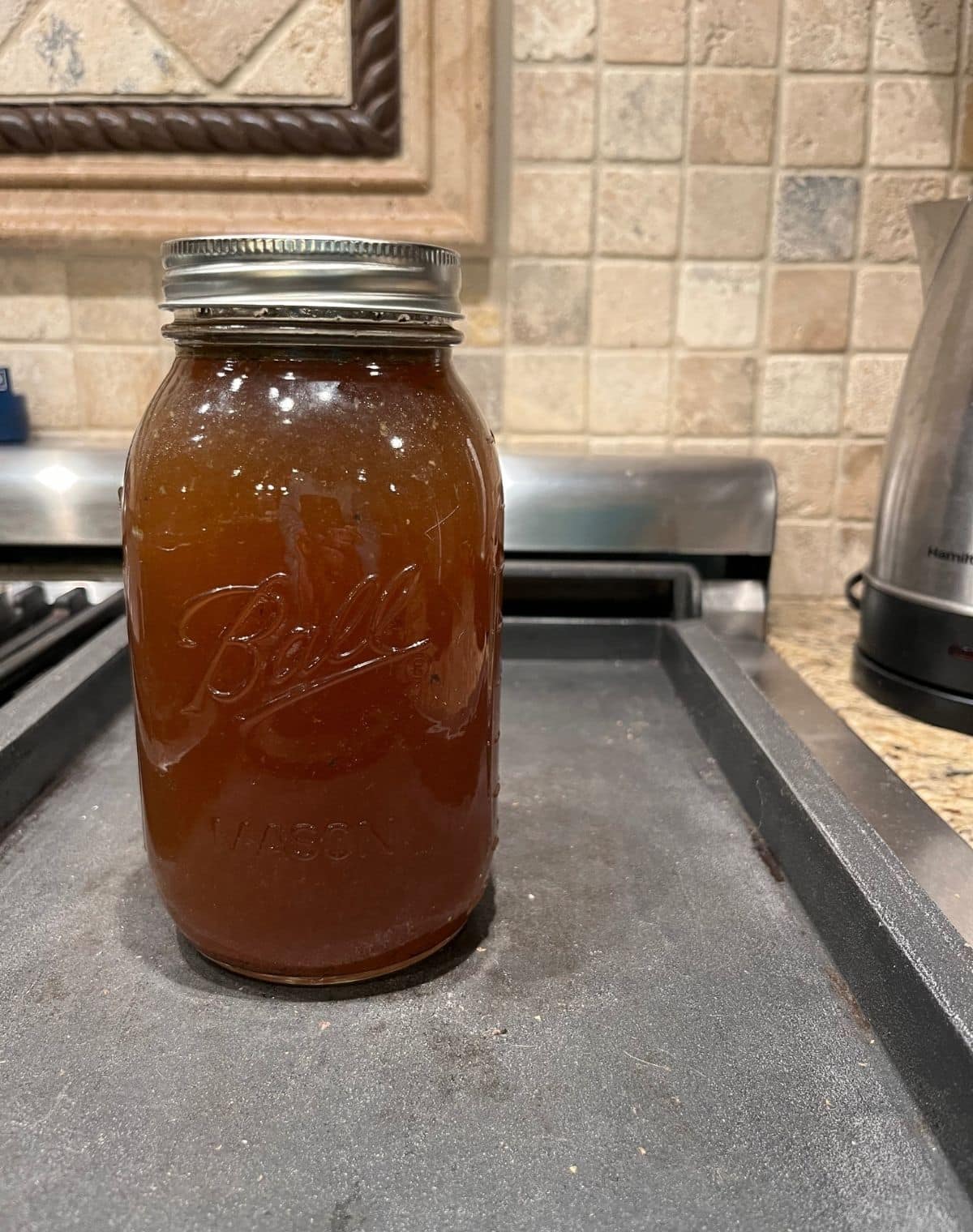 Bone Broth in Mason Jar on stove