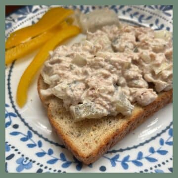 Dill Pickle Tuna Salad on a plate with Peppers in the background