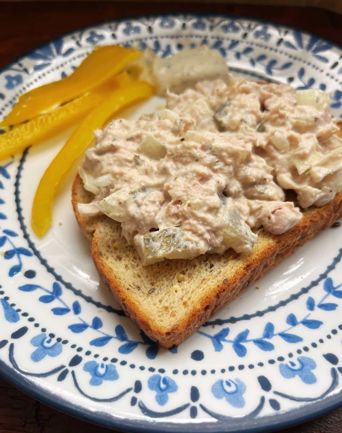 Dill Pickle Tuna Salad on a plate with Peppers in the background