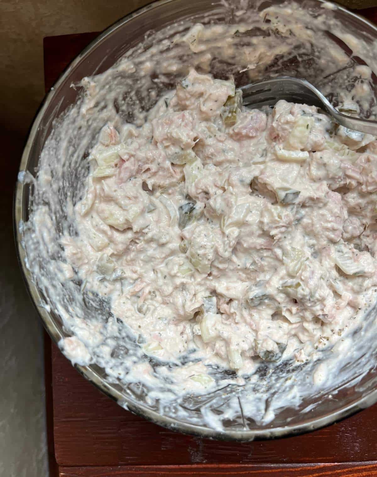 Tuna salad ingredients in a bowl mixed