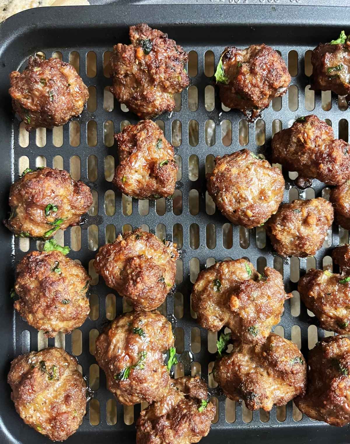 Cooked Bison Meatballs on an airfryer tray