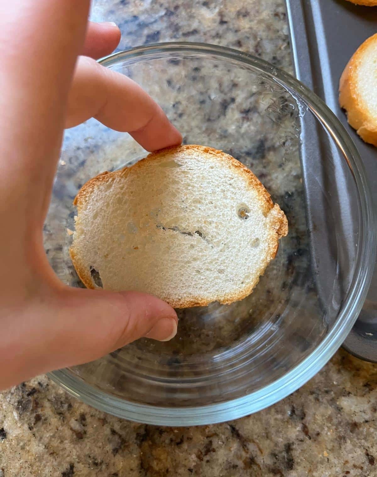 Bread getting dipped into oil