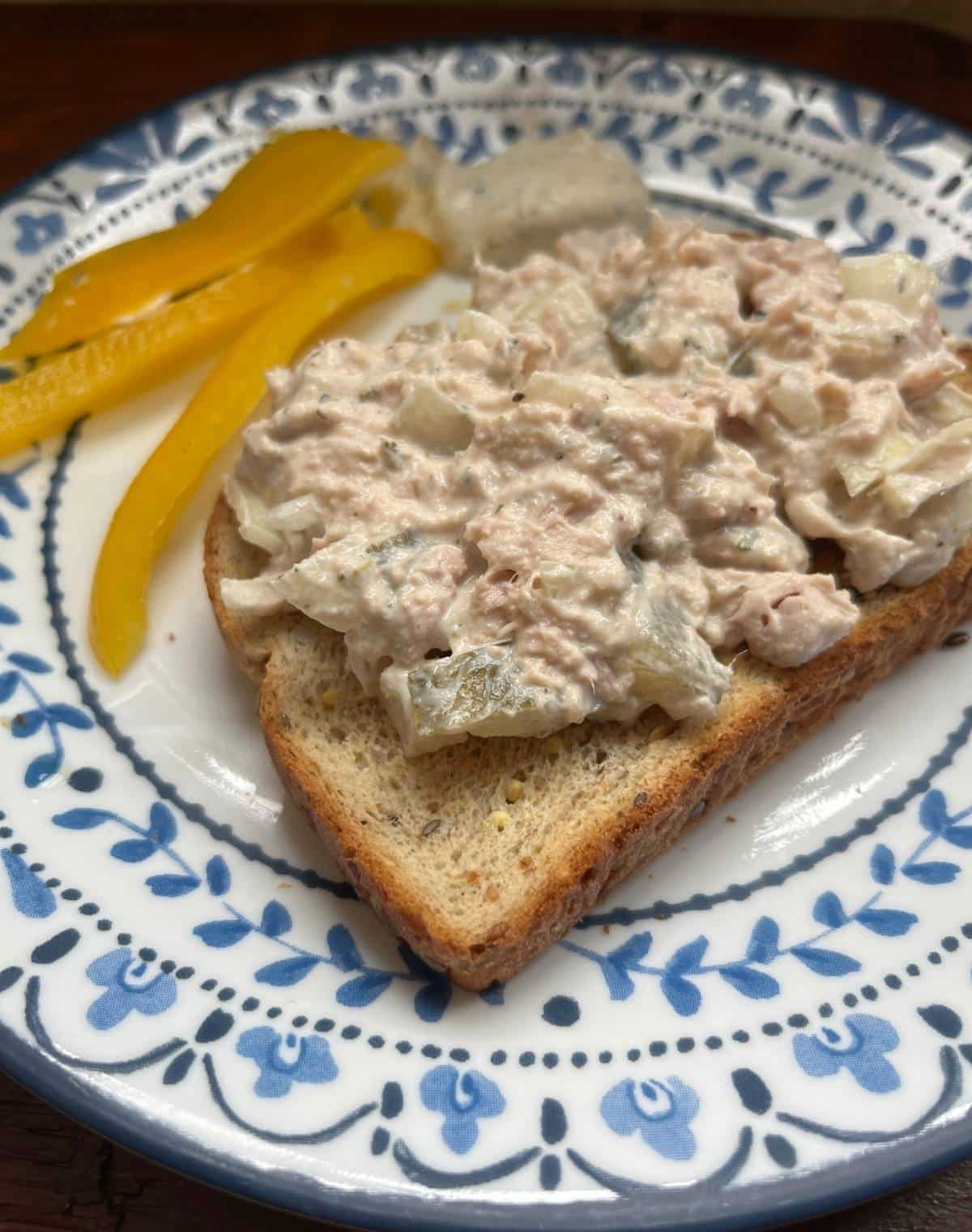 Dill Pickle Tuna Salad on a plate with Peppers in the background