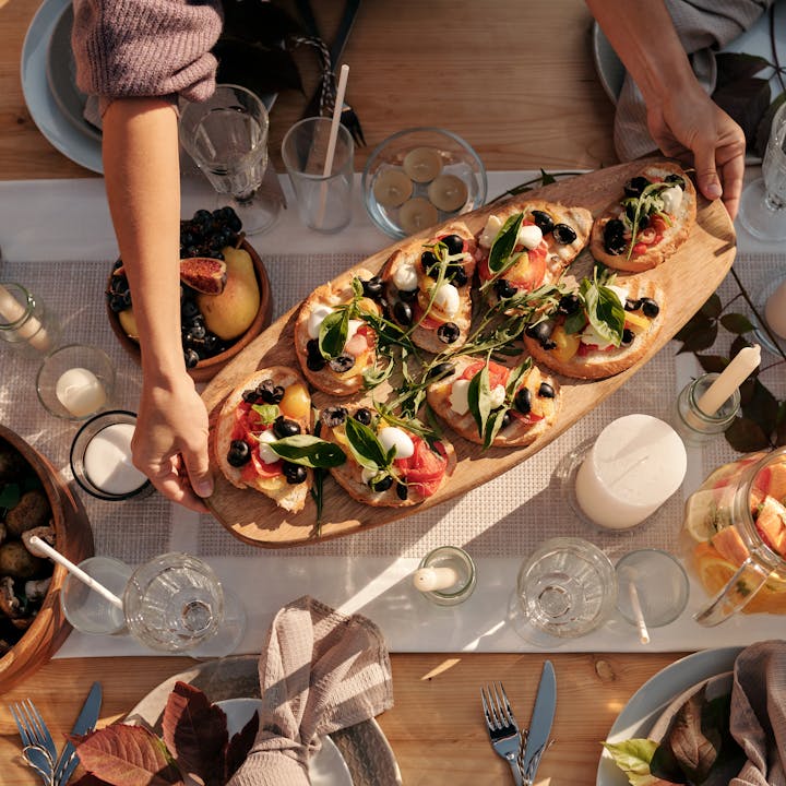Top view of a gourmet dining table with elegant bruschetta served at a dinner party, ready for celebration.