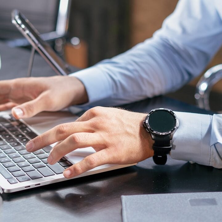 Person using a laptop at a desk to work with artificial intelligence
