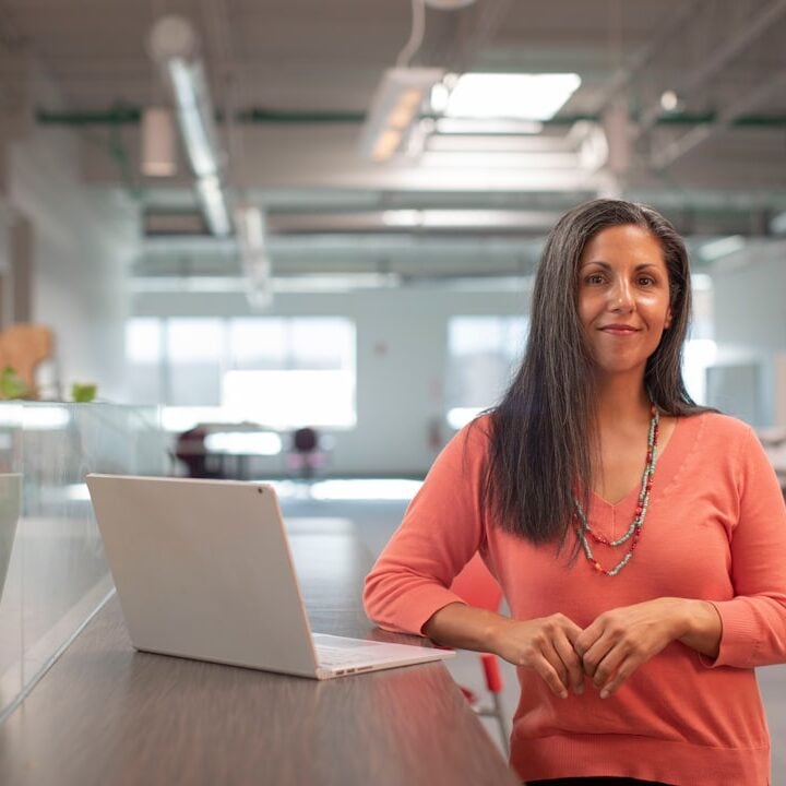 Professional woman working at a laptop in an office
