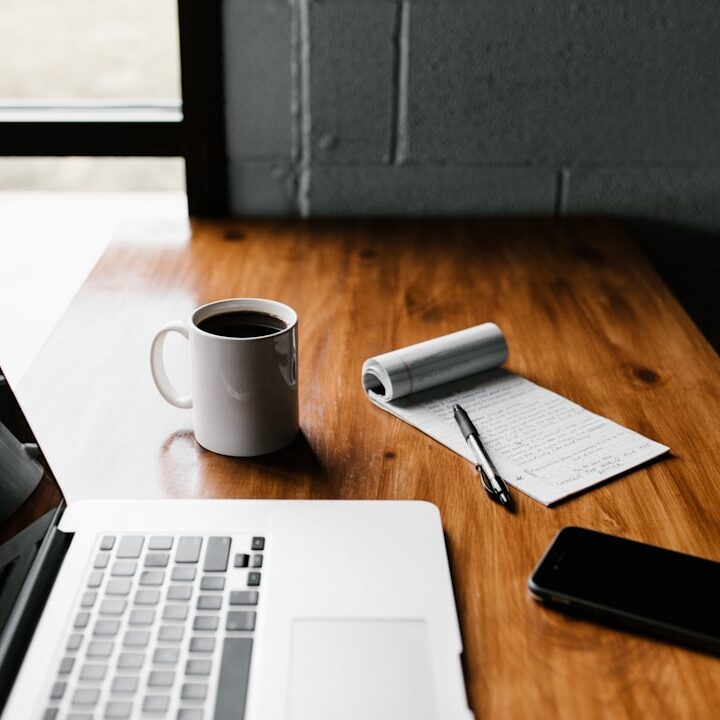Laptop and notebook on a desk for planning work
