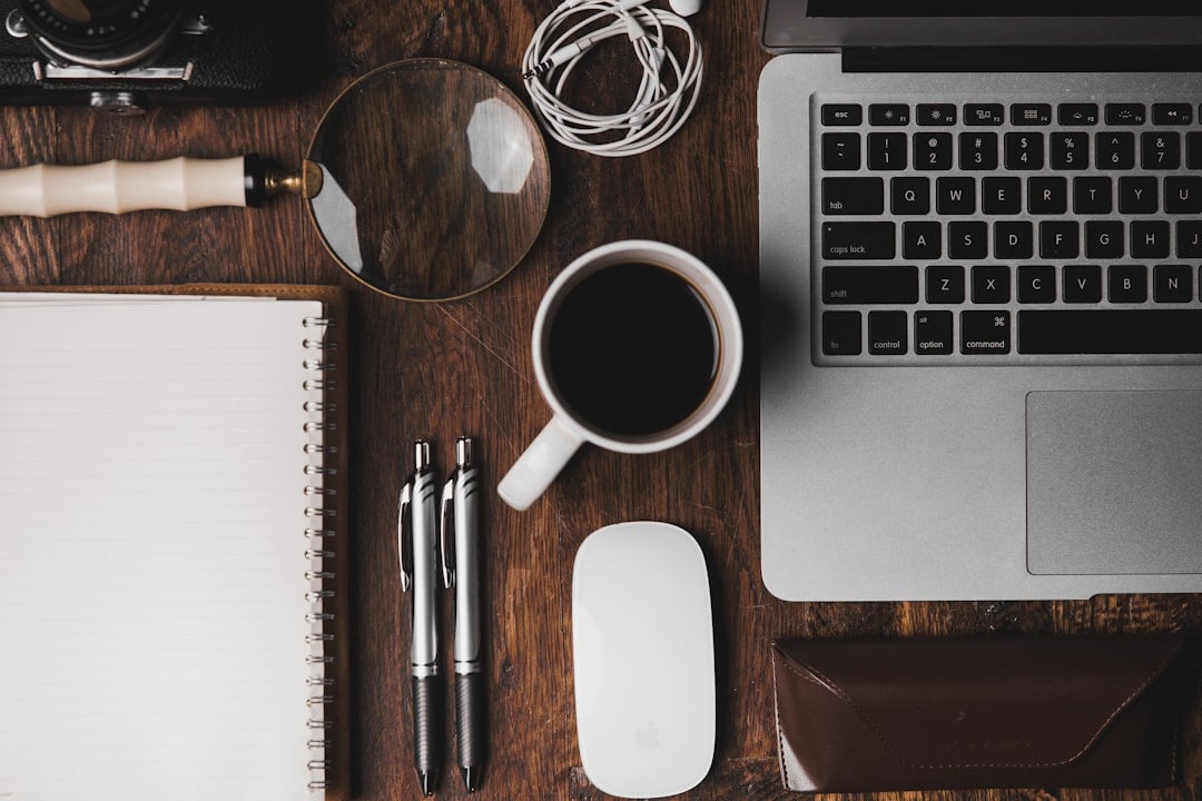 Laptop, notebook, coffee, and work essentials on a desk